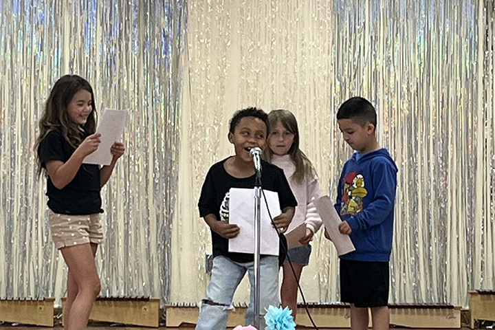 Students act out a scene on stage