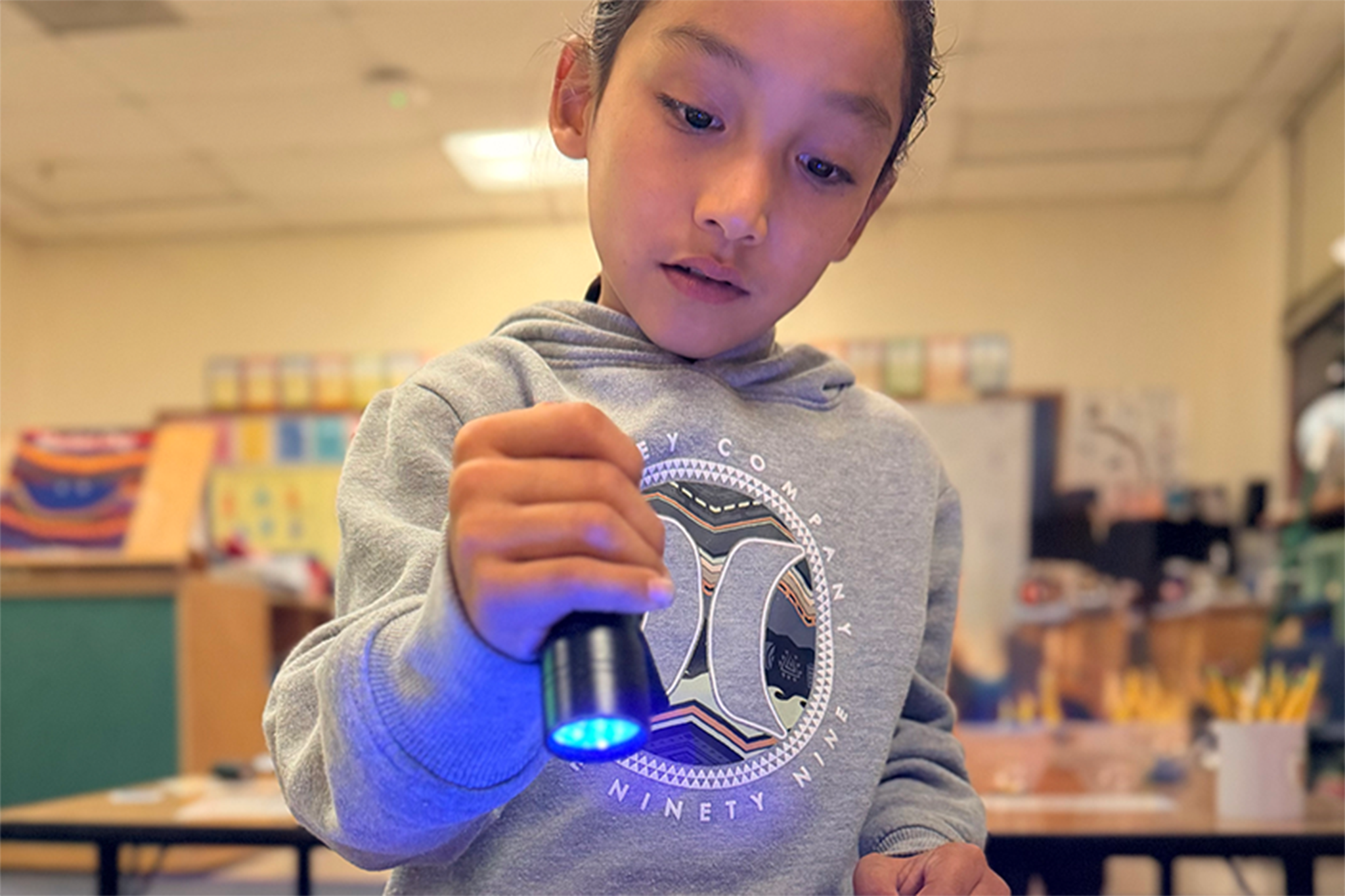 A boy shines a flashlight