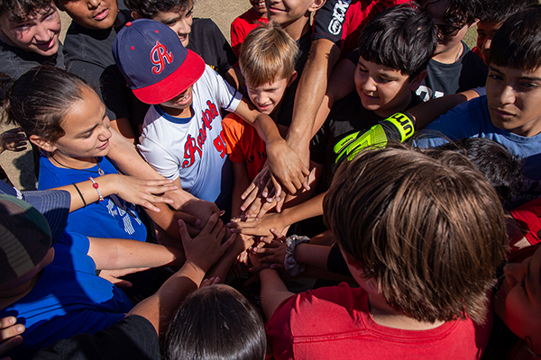 Students put their hands in before the soccer game