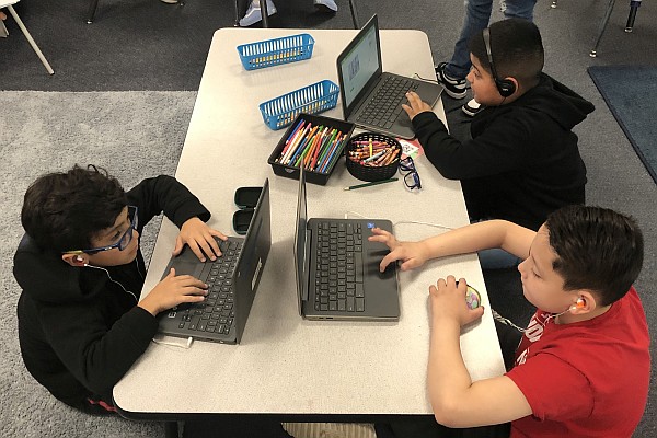 Three students working on their Chromebooks