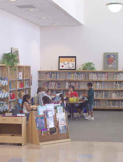 View of the library showing a teacher and students