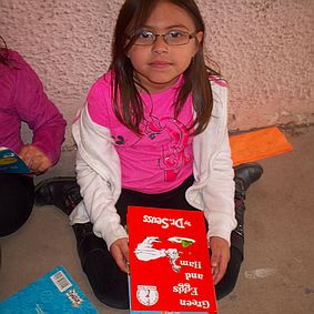portrait of a young girl with a dr. Seuss book